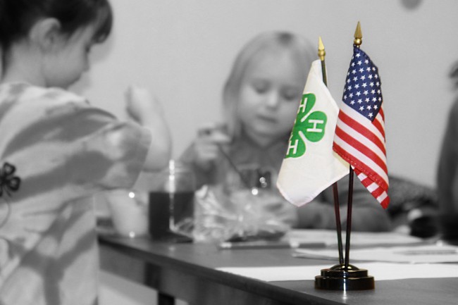 4-H flag with American flag on table