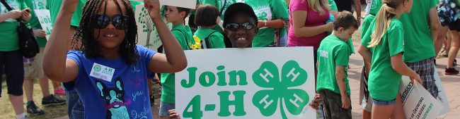 4Hers holding up Join 4-H sign