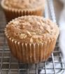 Oat muffins resting on a cooling rack.