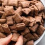 Chocolate chex mix pieces in a bowl.