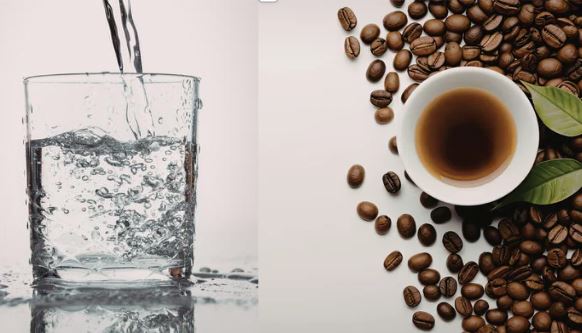 Photo of a glass of water next to a cup of coffee with coffee beans surrounding the coffee cup.